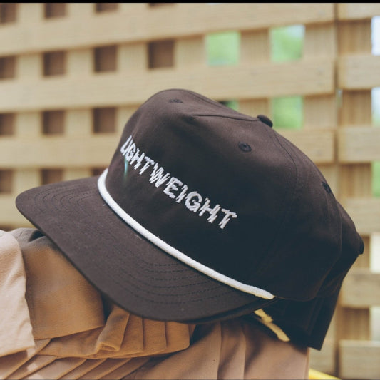 Black cap with 'LIGHTWEIGHT' text on a blurred background